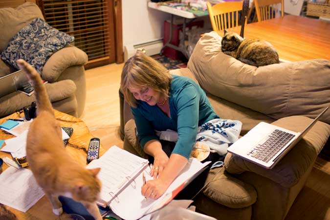 Penny tackles late-night paperwork, with the couple’s two cats nearby.