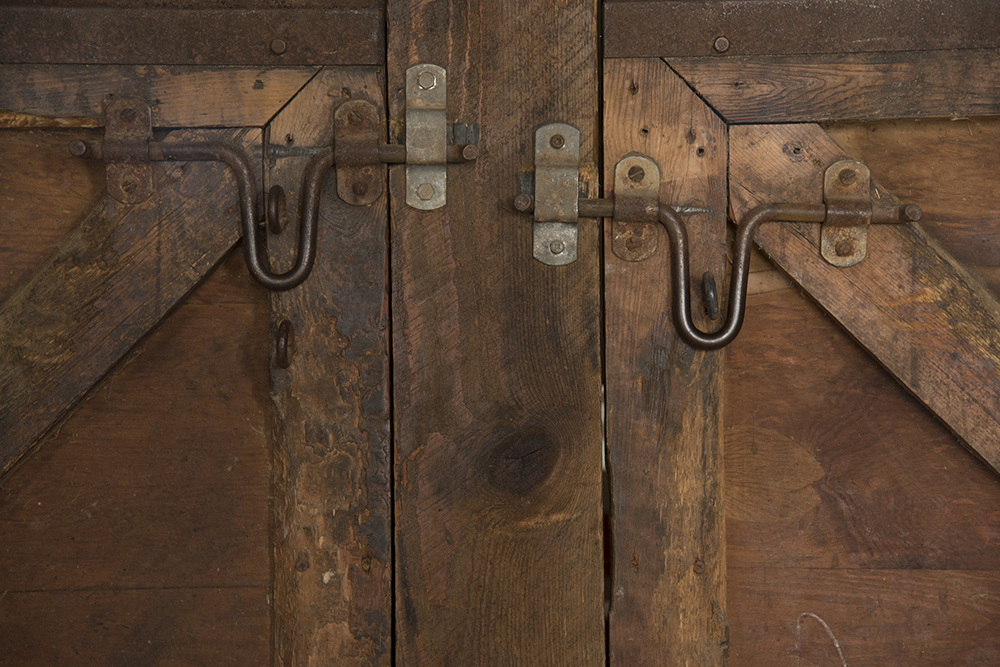 A detail of weathered doors in the former horse barn at Morgan Hill Farm.