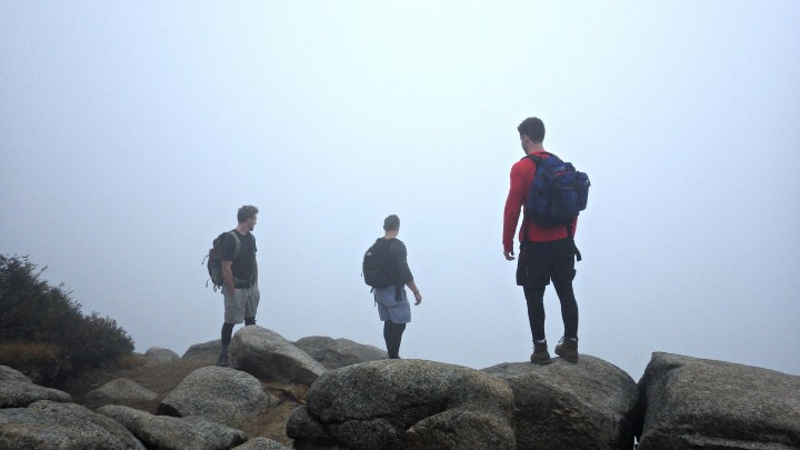 Hikers Ken Carr, Tony Quintilliani, and Brian Briggs stare into the foggy abyss from the same scenic viewpoint in previous picture.