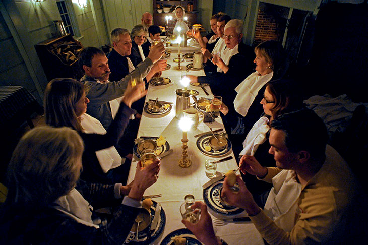 When the food is cooked, guests sit down to enjoy dinner.