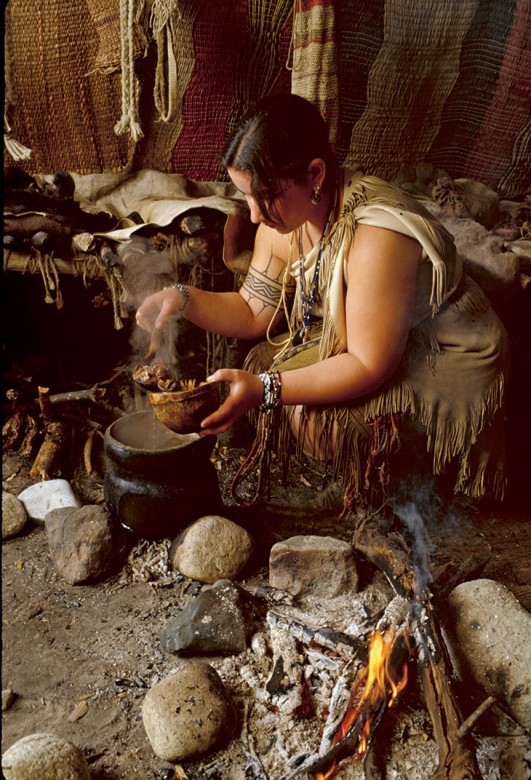 Melanie Roderick of the Wampanoag Indigenous Program makes turkey soup in a clay pot at Plimoth Plantation.