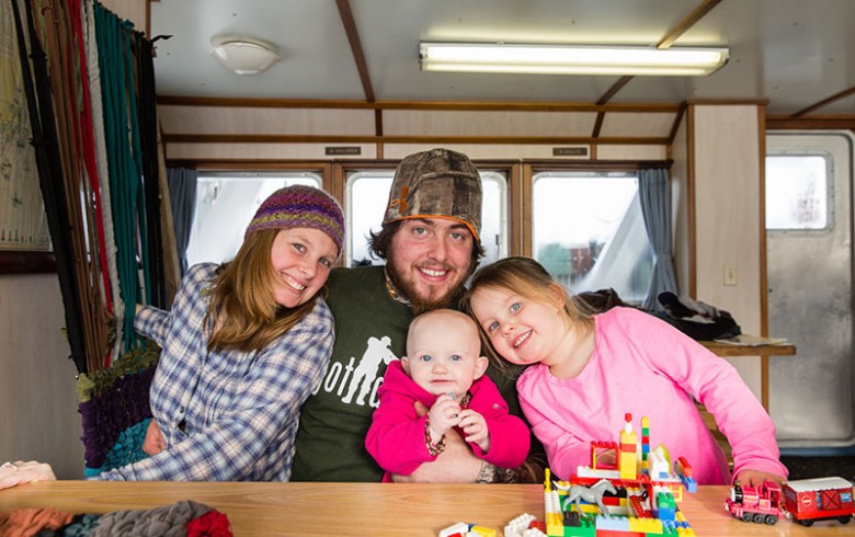 A Frenchboro lobsterman and his family gather aboard the Sunbeam.