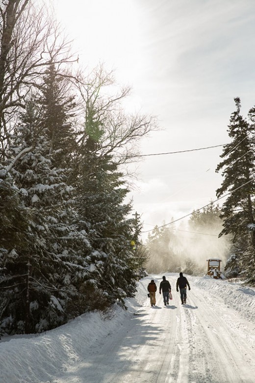 Crew members from the Sunbeam walking to visit residents on Isle au Haut's snowy back roads.