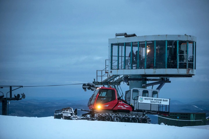 The Motor Room Bar snowcat waits outside of the floor-to-ceiling windowed room while guests enjoy cocktails and d'oeuvres. 