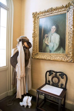 Inside the museum, former home of the Griswold family, a portrait of Miss Florence by Alphonse Jongers graces the hallway. Jongers spent the summers between 1900 and 1904 in Old Lyme. Period clothing dates to the art colony’s heyday, c. 1910. The Chinese chair came from Boxwood, the Old Lyme home of Miss Florence’s family.