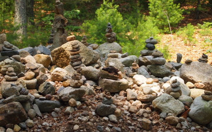 Stacks of rocks are next to the sign at Thoreau's cabin site. This is a practice called rock balancing.