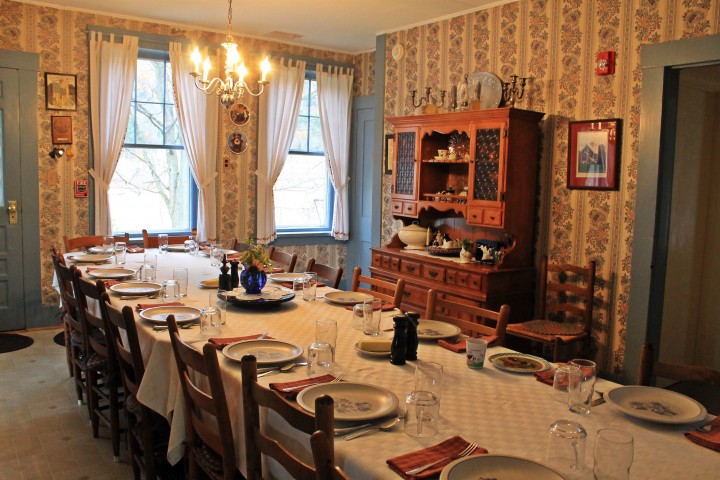 The dining room table awaits 13 guests for this evening's meal