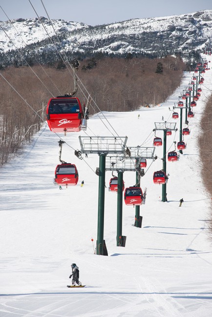 The bright red gondolas punctuate the ski slopes at Stowe.