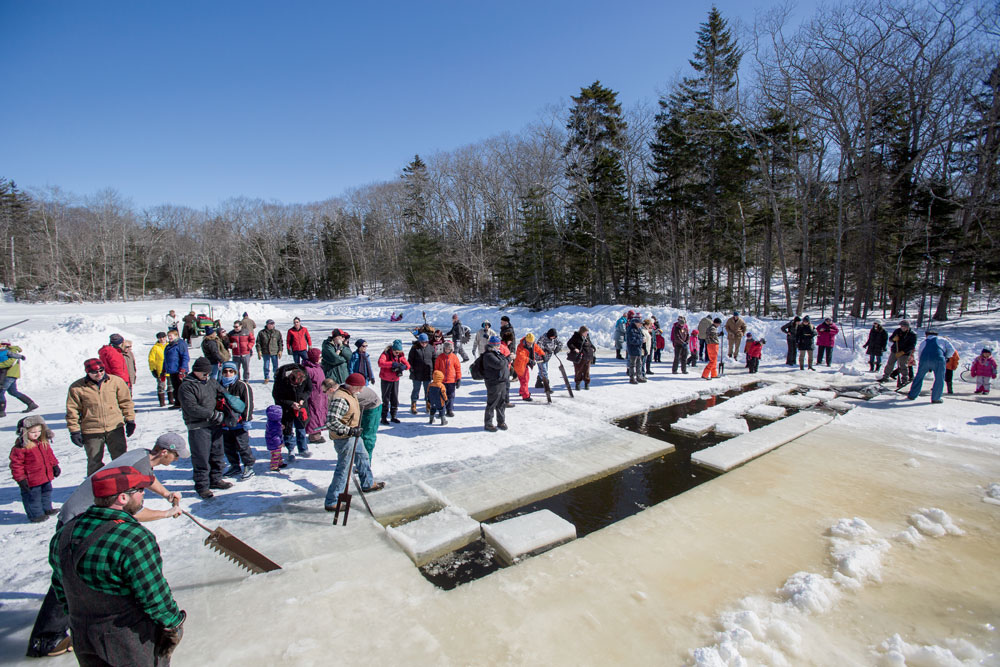 It’s a community gathering every February as residents and visitors in South Bristol, Maine, wield saws, “busting bars,” and pike poles to harvest ice from Thompson Pond.