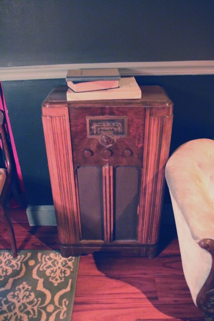An old radio tucked in a corner. codex nashua speakeasy