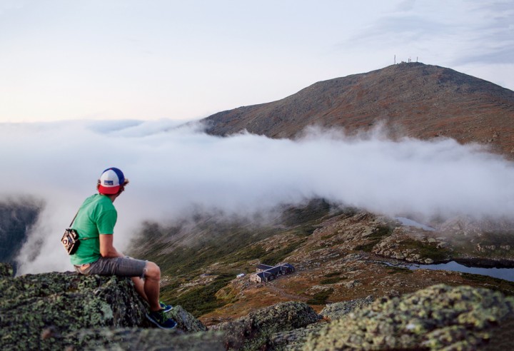 Mount Washington’s summit rises above the clouds and Lakes of the Clouds Hut. Jarrod (pictured here) wrote: “Halfway through dinner the clouds began to part … I grabbed my camera and darted up the mountain. The view was breathtaking as the clouds shifted around and layers of clouds collided. Once dusk came on, you could see city lights on the horizon.” 