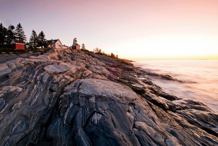 Dawn brushes the rocks below Pemaquid Point Light, featured on the Maine state quarter.