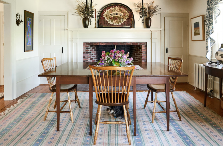 The dining room features one of the farmhouse's six working fireplaces.