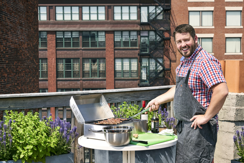 Chef Gilson grilling up Korean beef short ribs on his friend’s Boston roof deck. Electric grills are a safe and convenient grill option for those with city decks, rooftop living space, campers and boats.